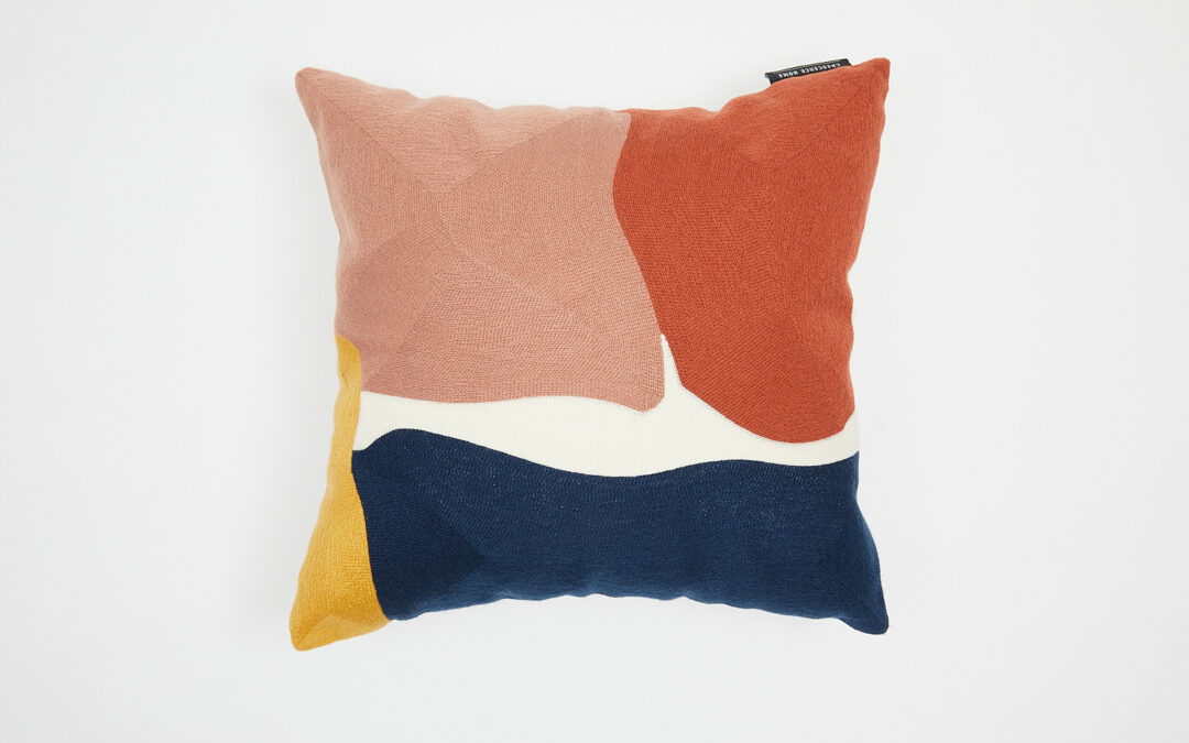 Brightly patterned cushion photographed from above
