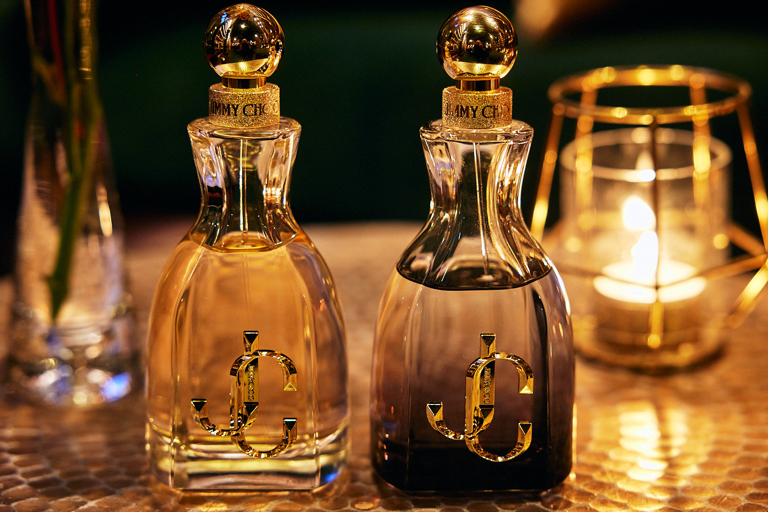 Bottles of I Want Choo Forever perfume lit by candlelight