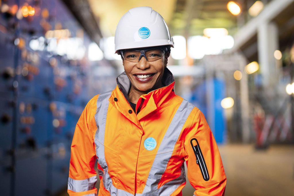 Headshot of a Thames Water professional women, in high vis jacket and helmet